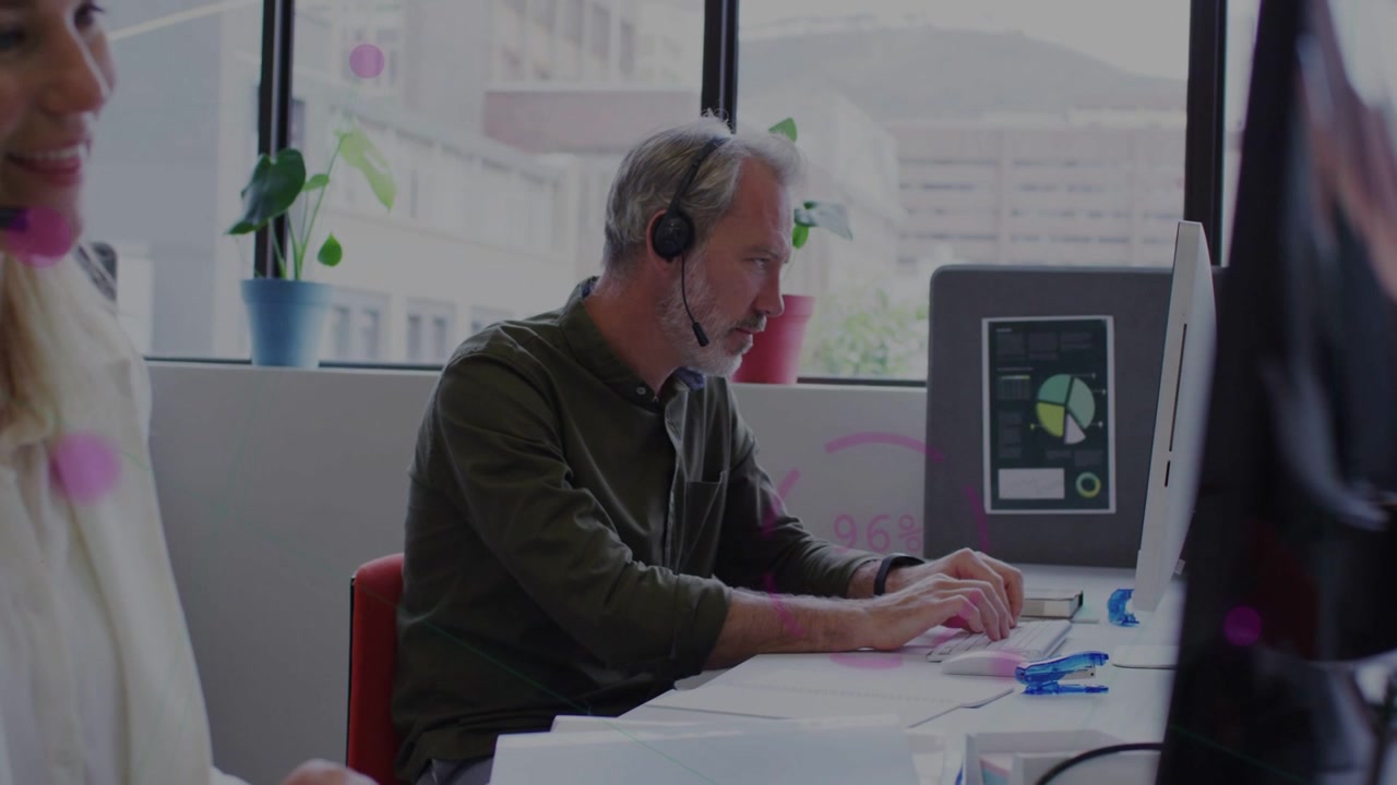 Male agent receiving headset call, typing and updating pie chart dashboard for business