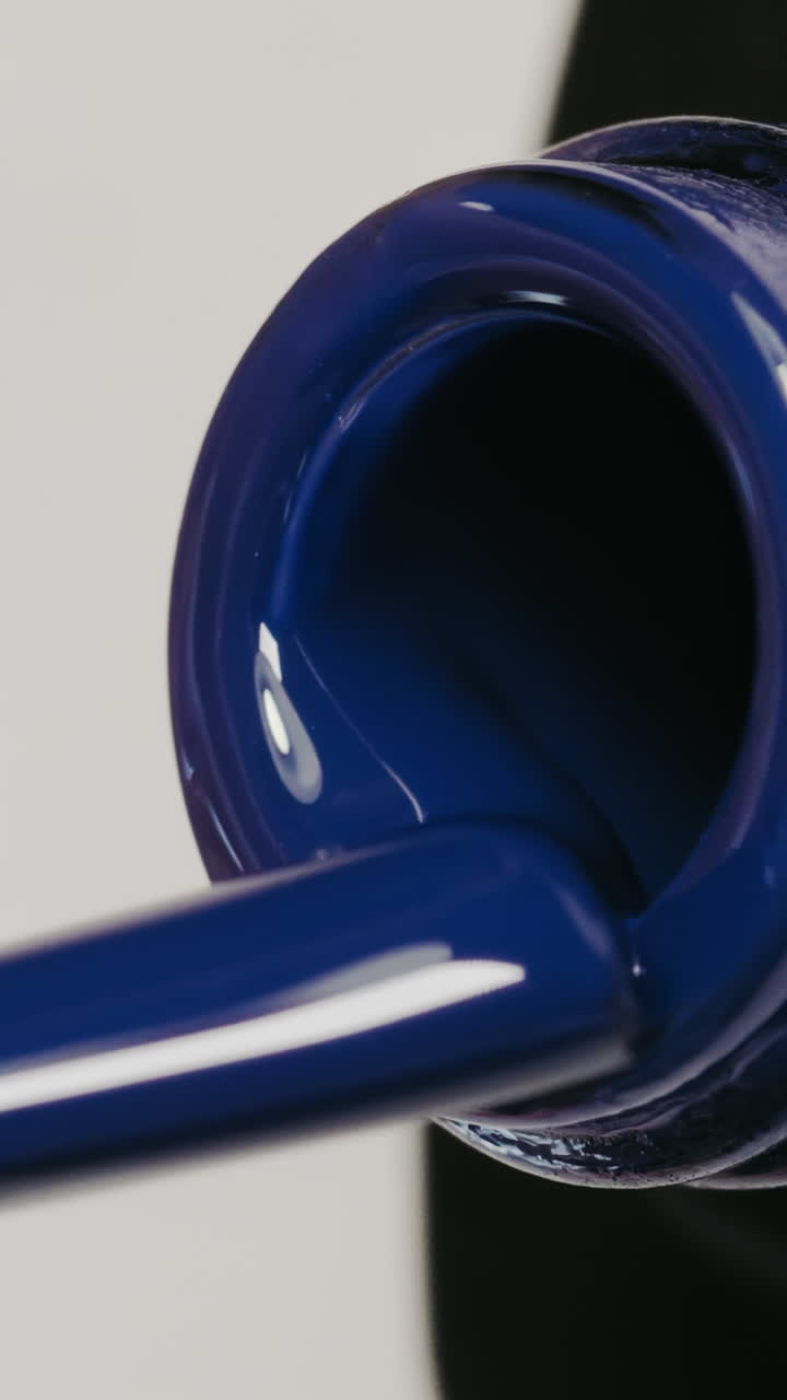 Close-up of a dark blue nail polish bottle