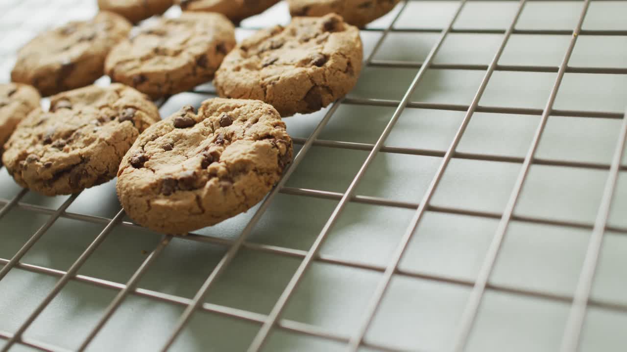 Video of rows biscuits on a baking rack over white background