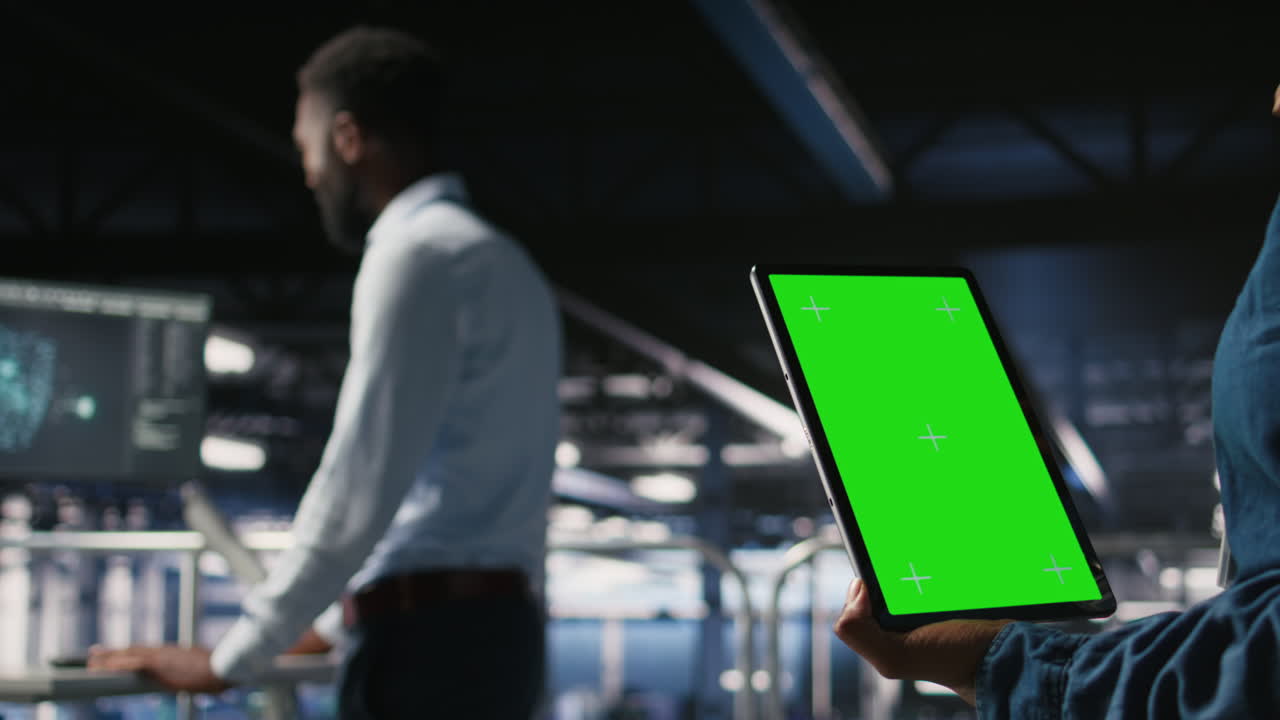 Close up of server hub admin using isolated screen tablet next to colleague