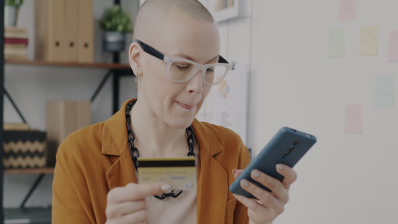 Woman making mobile payment in office