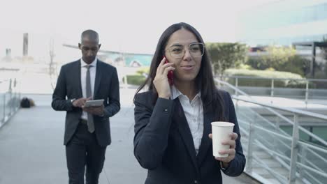 business people with digital devices on street