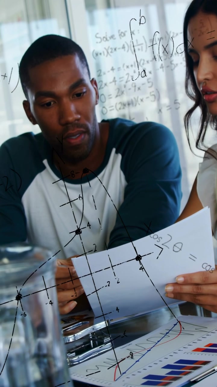 Vertical video: Woman showing chart to man at table, math overlay aiding business report review
