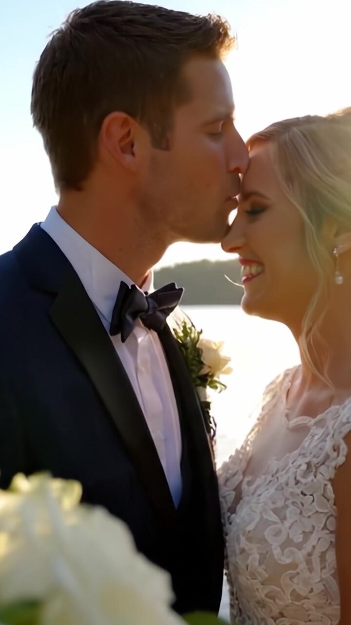 A Heartwarming Moment of Newlyweds Sharing Joyful Laughter by the Water's Edge, Surrounded by the Beauty of Nature and Love on Their Special Day