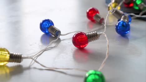 christmas led bulbs in blue, red, yellow, and green colors are displayed on a white surface