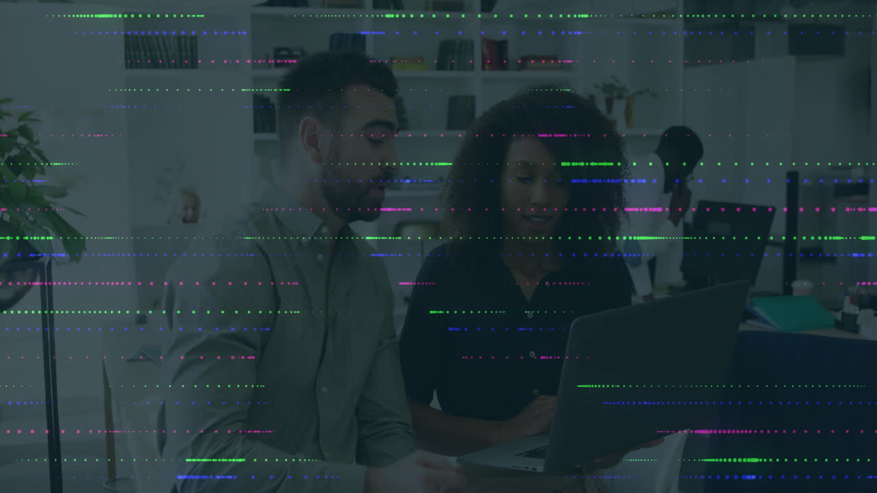 Diverse colleagues working on laptop with digital data processing animation overlay