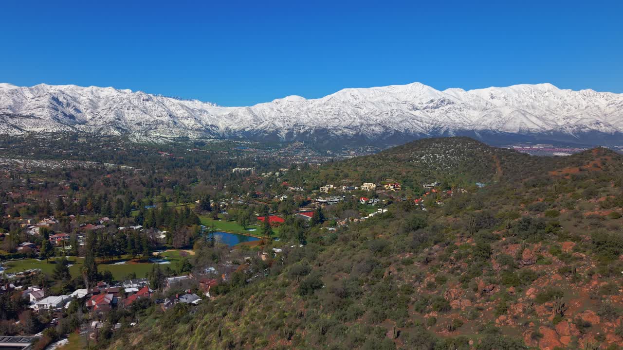 Aerial panoramic view of del Medio hill and the Lomas de La Dehesa golf course, in the eastern and exclusive sector of the city of Santiago, in the municipality of Lo Barnechea