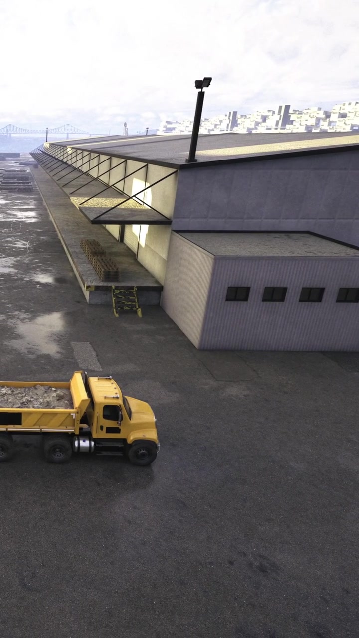 Construction site with yellow truck at warehouse in daytime