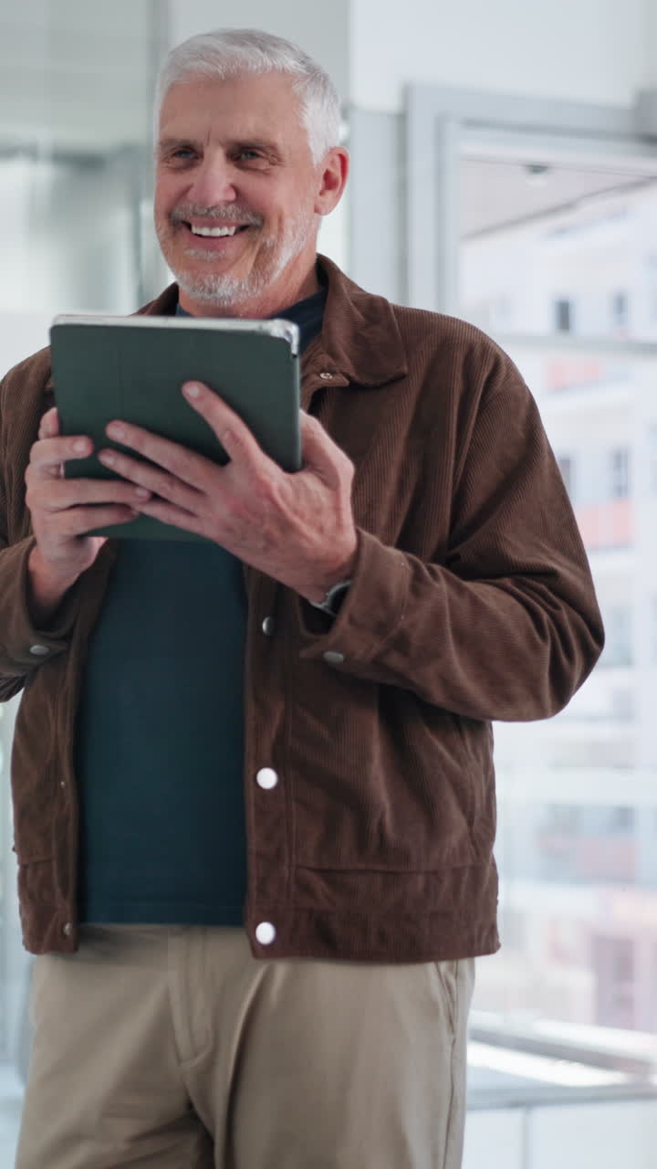 Happy Senior Man Using Digital Tablet Indoors