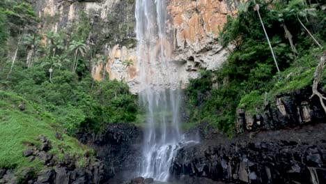 waterfall cascading in lush green forest