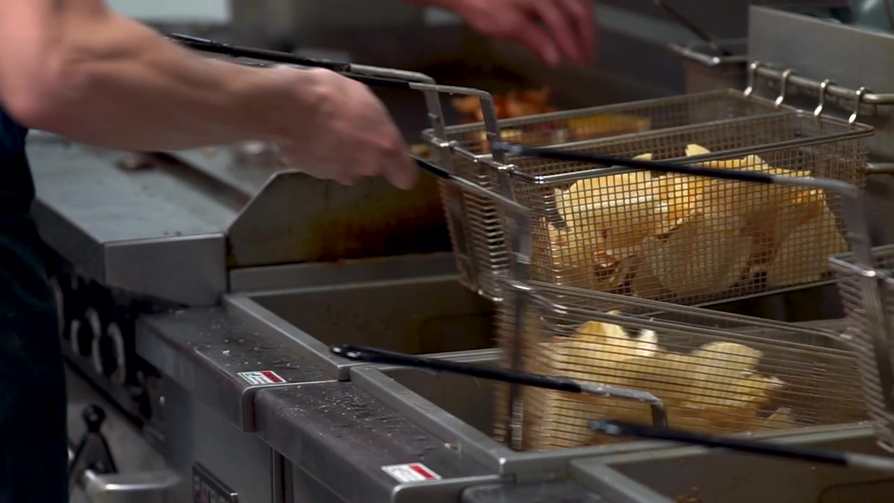 Tortilla Chips Coming Up From The Deep Fryer