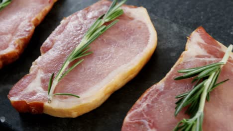 Raw-sirloins-arranged-on-the-board-with-rosemary