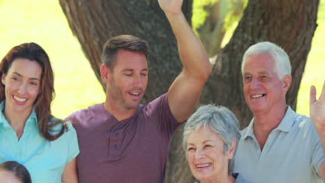happy multi generation family gesturing