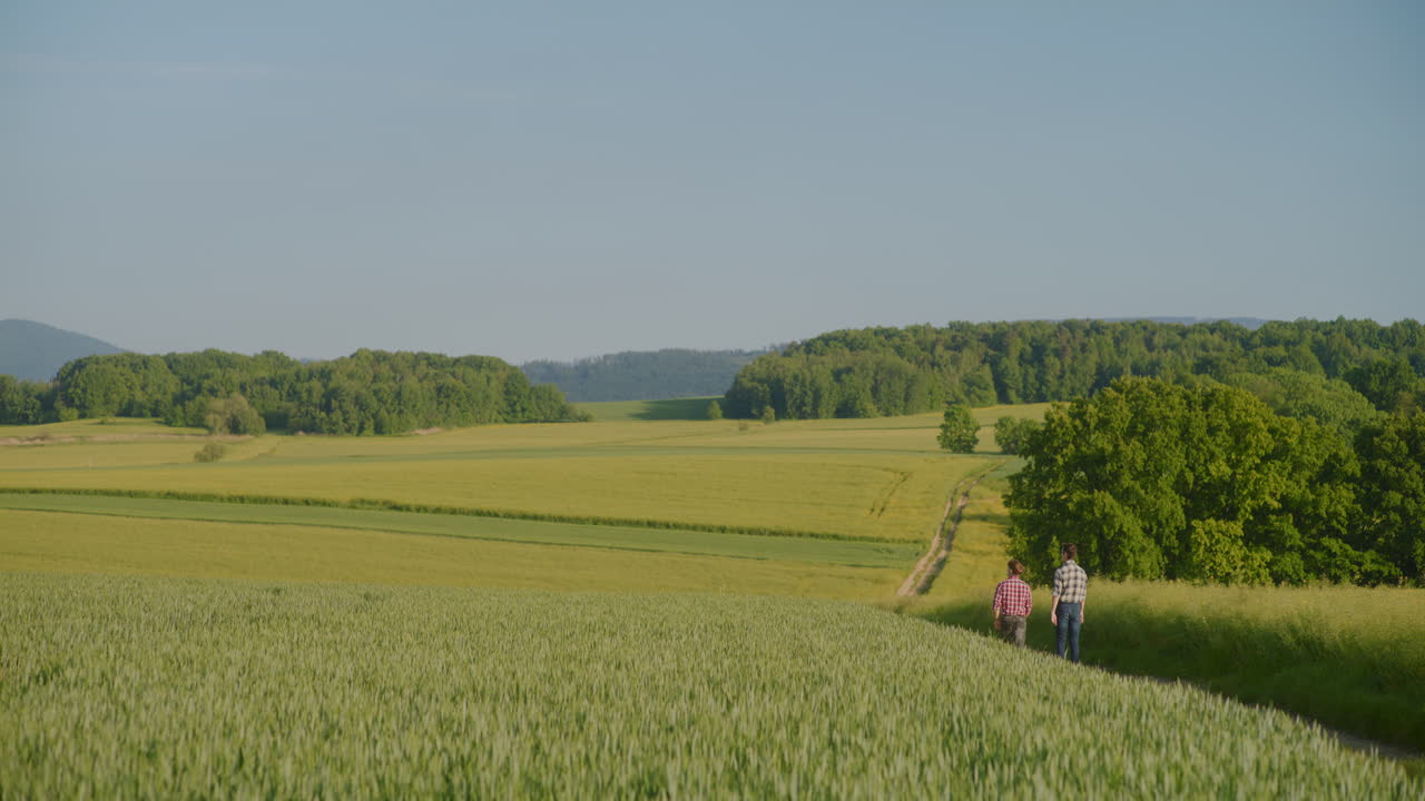 View of Rural Landscape with Two Men Walking Along Dirt Road
