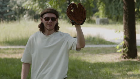 young man playing baseball in a park