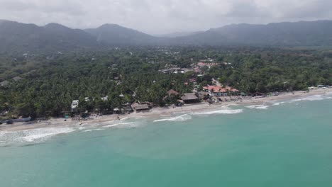 Aerial-establishing-shot-of-the-beautiful-coastline-and-beaches-at-Palomino