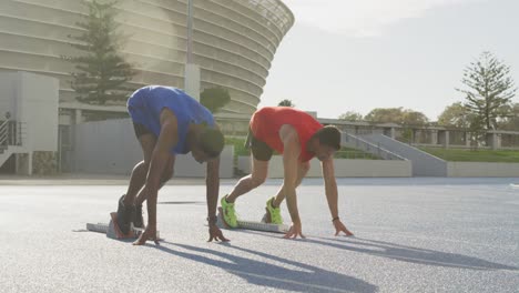 two athletes preparing for race in stadium