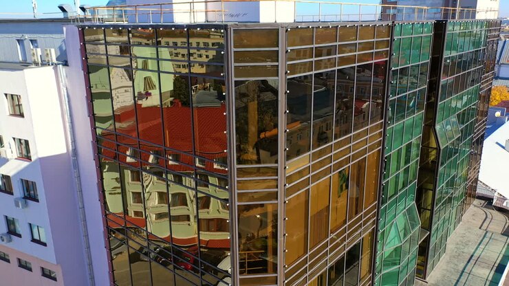Business centre with mirror windows in downtown. Main street with transport and people moving along. Top view.