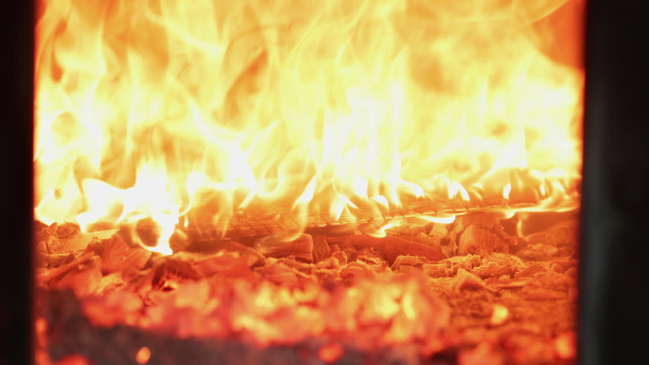 Charcoals And Wooden Logs Burning Inside The Traditional Oven For Baking In The Bakery.  - close up shot