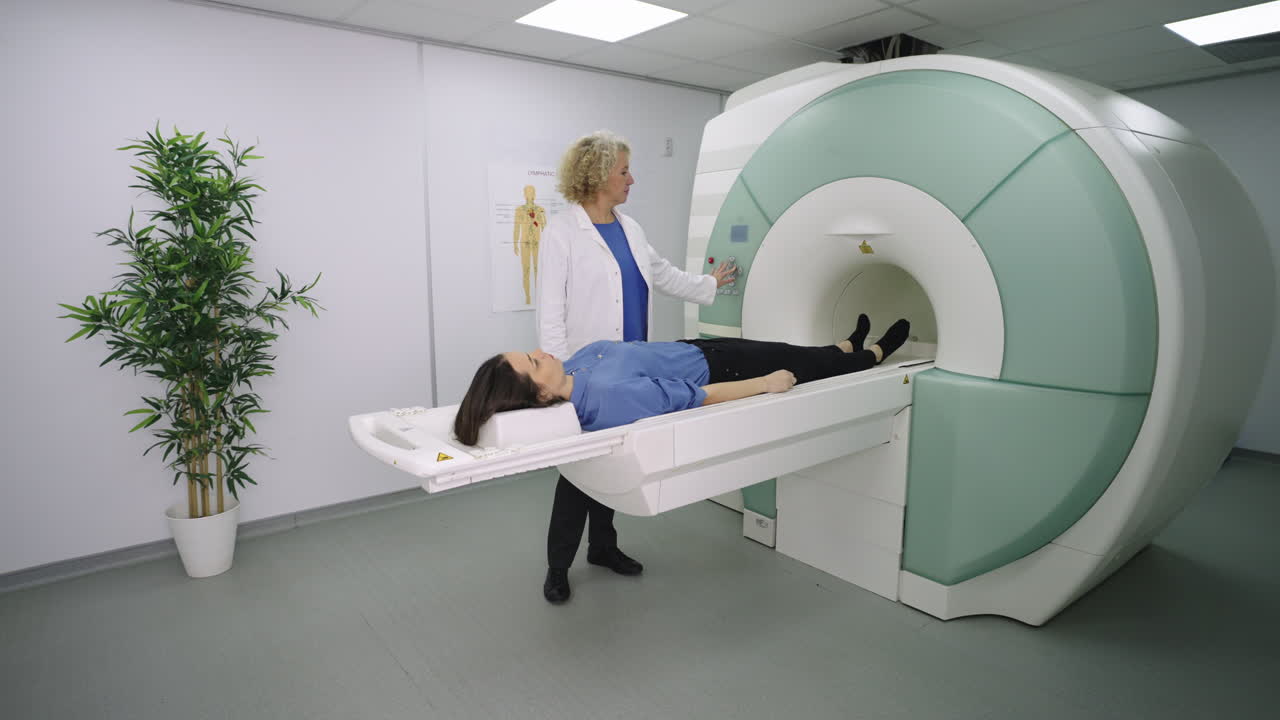 Patient Undergoing an MRI Scan Assisted by a Medical Professional
