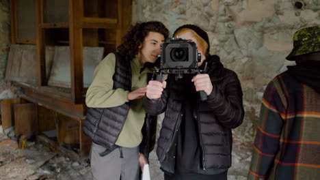 production team and cameraman recording a scene in a ruined building 2