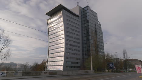 uniquely curved glass panel luxury office building reflecting the sun