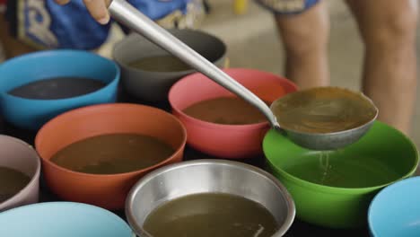 famine life live below the poverty line, feeding the poor, food distribution with bowls of nourishing lentil soup