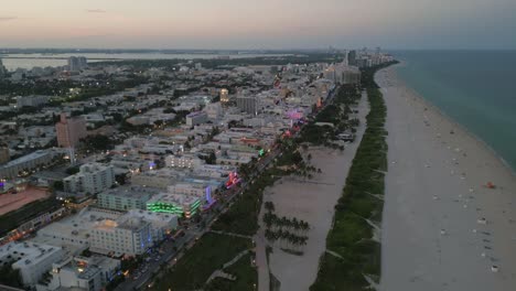 Miami-South-Beach-Wird-Nachts-Während-Der-Luftaufnahmen-Von-Drohnen-Bei-Sonnenuntergang-Beleuchtet