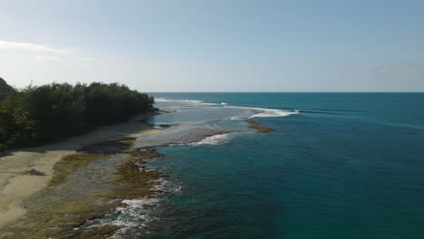 aerial tracking shot of ha'ena beach moving outwards to the ocean