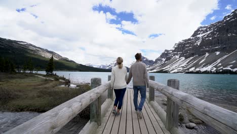 young couple enjoying nature at mountain lake, canada