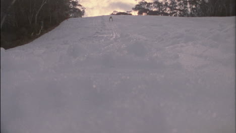 a person skies down a slope 1