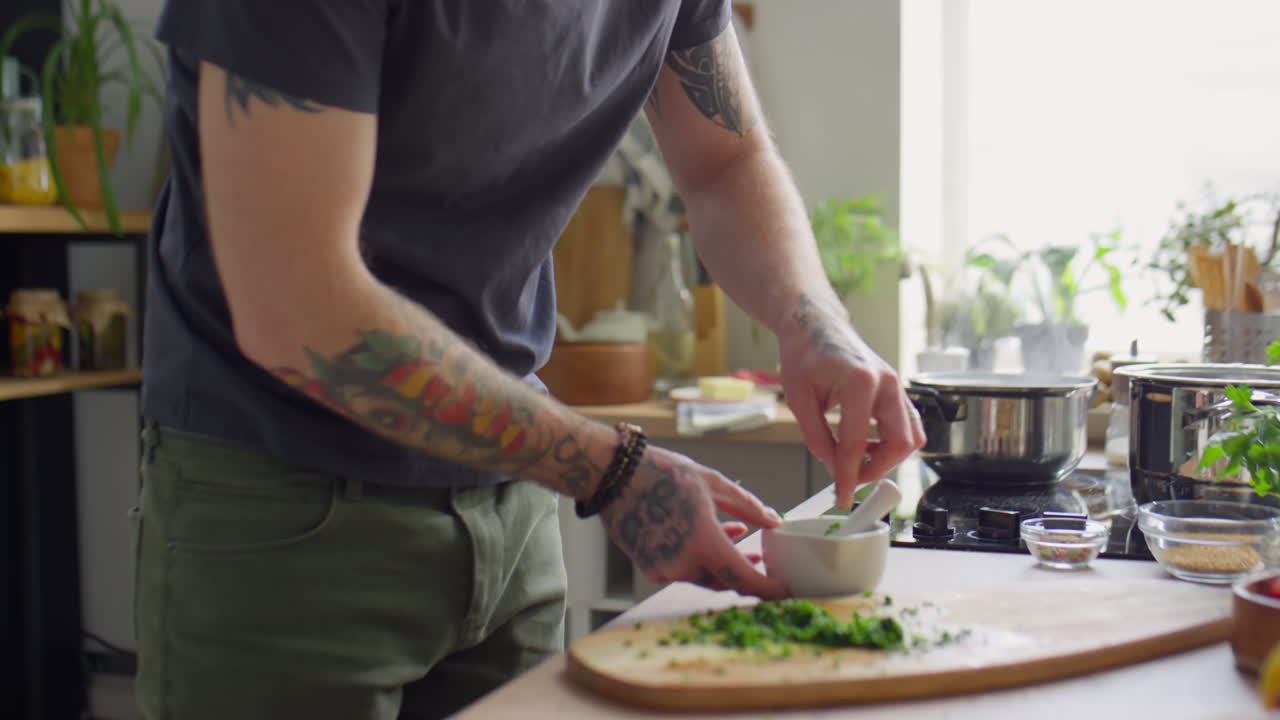 Chef Putting Chopped Herbs into Mortar