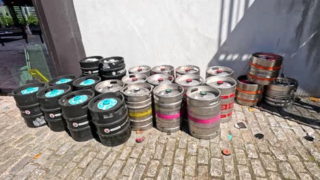 beer kegs stacked outside a building