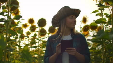 The-camera-follows-and-moves-a-woman-farmer-with-a-tablet.-The-farmer-goes-in-front-of-the-camera-with-a-tablet-and-uses-modern-technology-for-his-small-business.