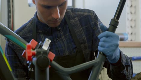 man repairing bicycle in workshop 4k