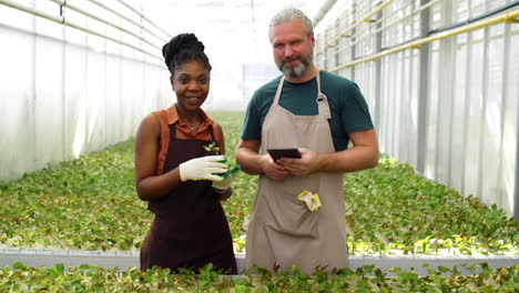 Portrait-of-Multiethnic-Man-and-Woman-at-Work-in-Flower-Greenhouse