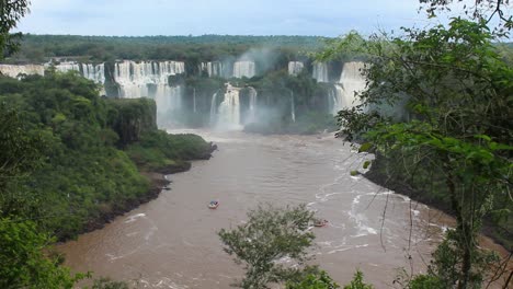 sightseeing boats on iguazu river next to iguazu waterfalls, brazil