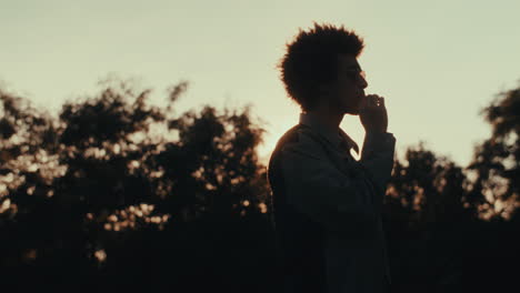 man smoking at sunset