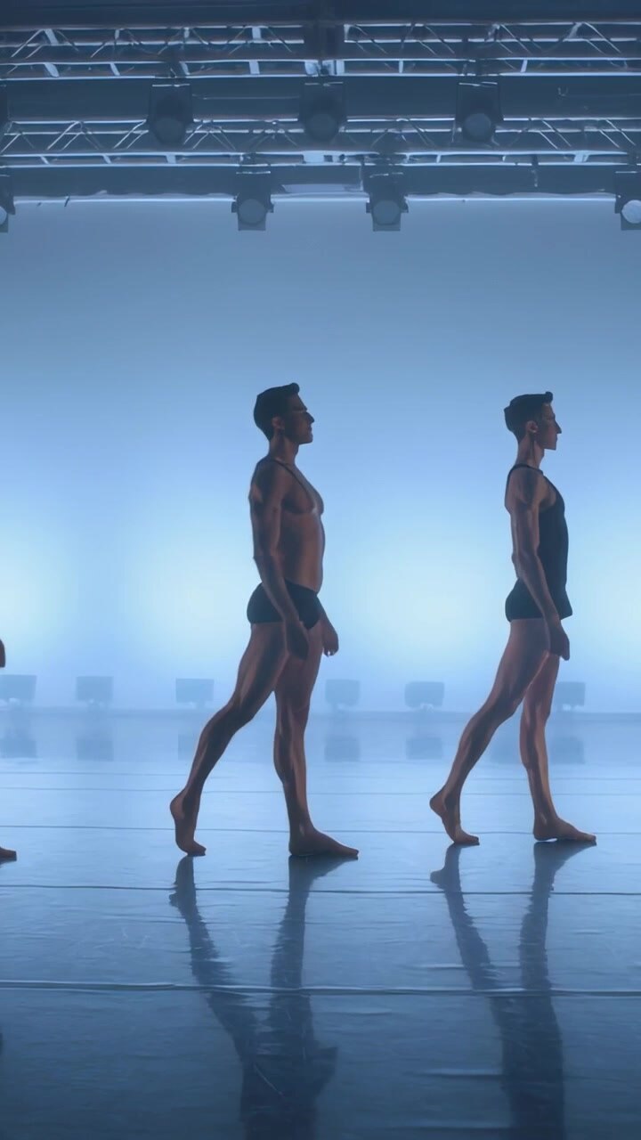 Vertical video: Light cue starting three dancers walking in sync across blue stage, two in briefs