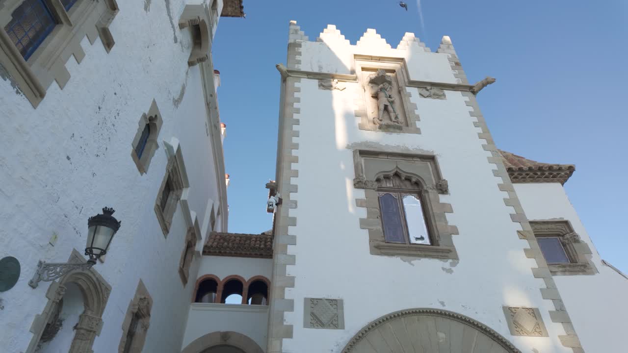 Elegant historic building with arched entrance and stone details on Carrer de Fonollar Sitges Spain