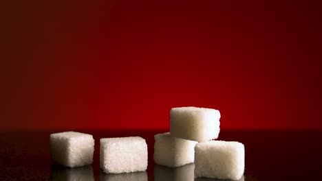 sugar cubes on red background