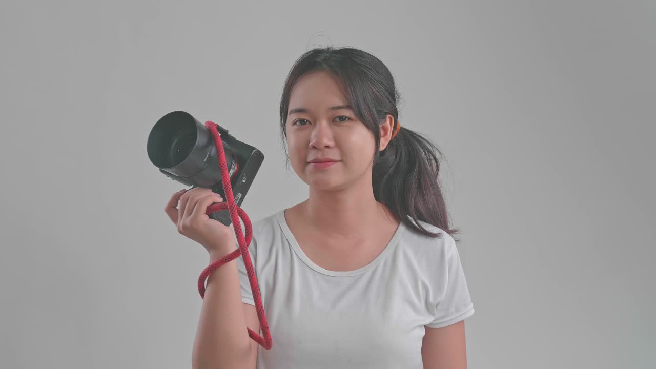 Young Asian Female Photographer Standing In Studio
