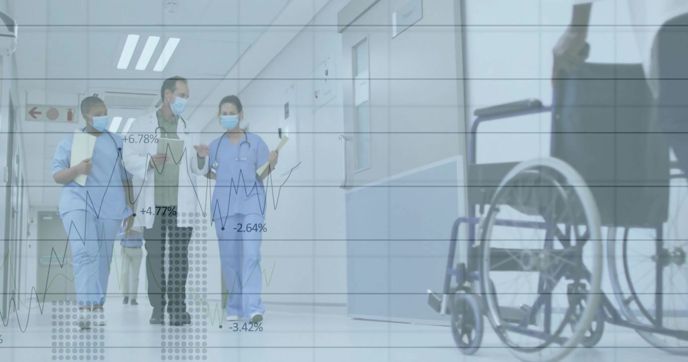 Squadra medica che cammina in corridoio, avviando una discussione sulle metriche e animando grafici accanto a una sedia a rotelle