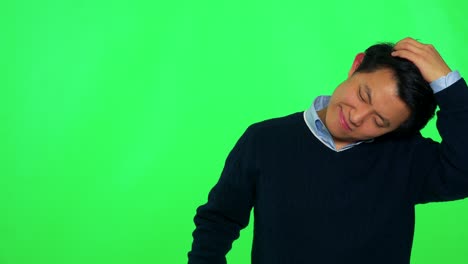 a young asian man does stretching - green screen studio