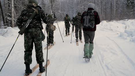 military personnel skiing in a snowy forest