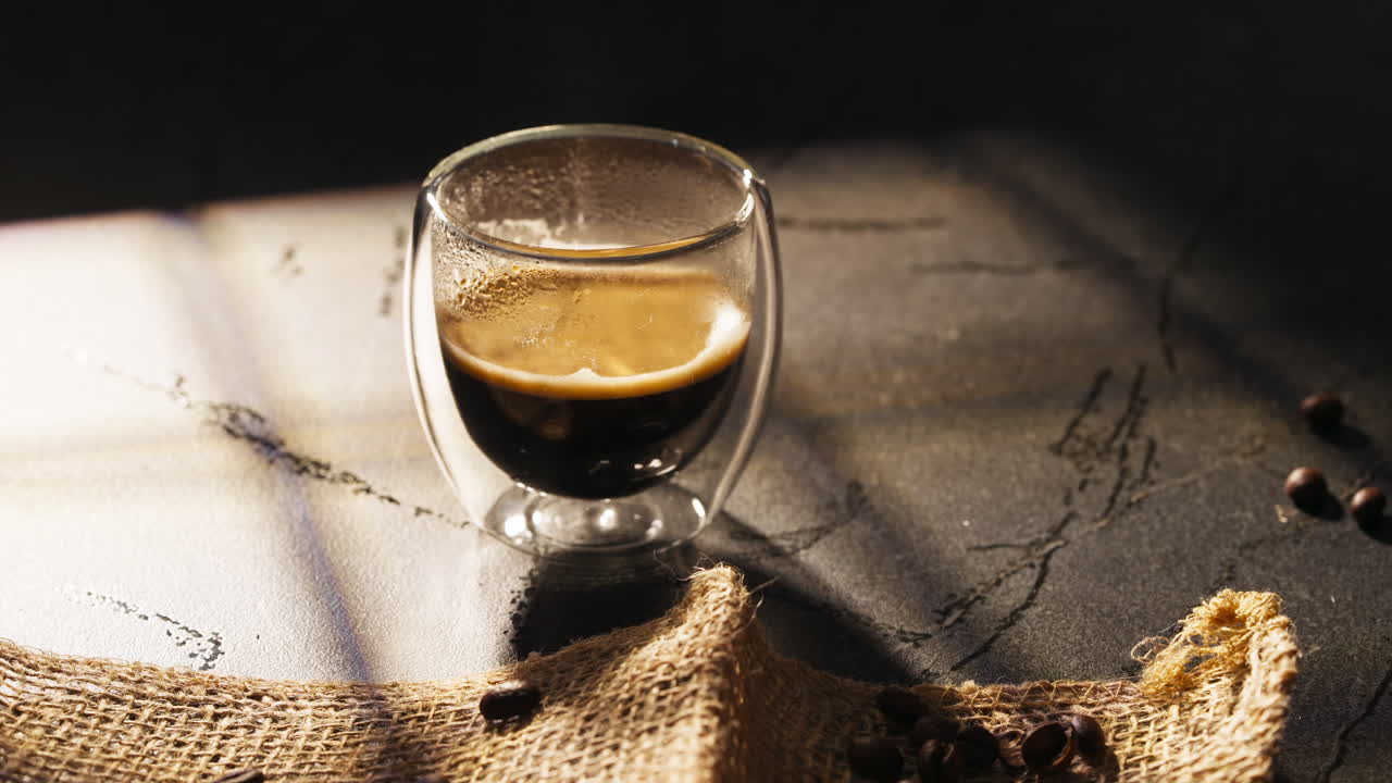 Handheld shot of cup of steaming coffee ready to be enjoyed, interior