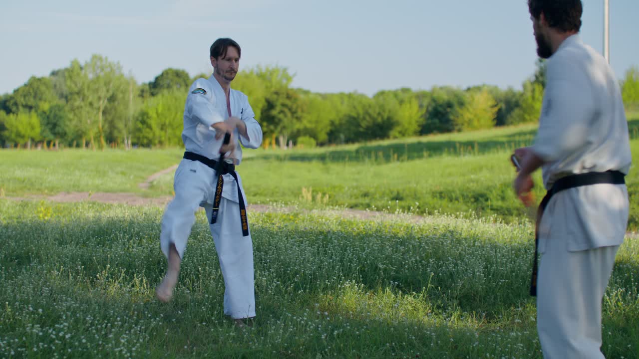 Allenamento di karate all'aperto con i nunchaku