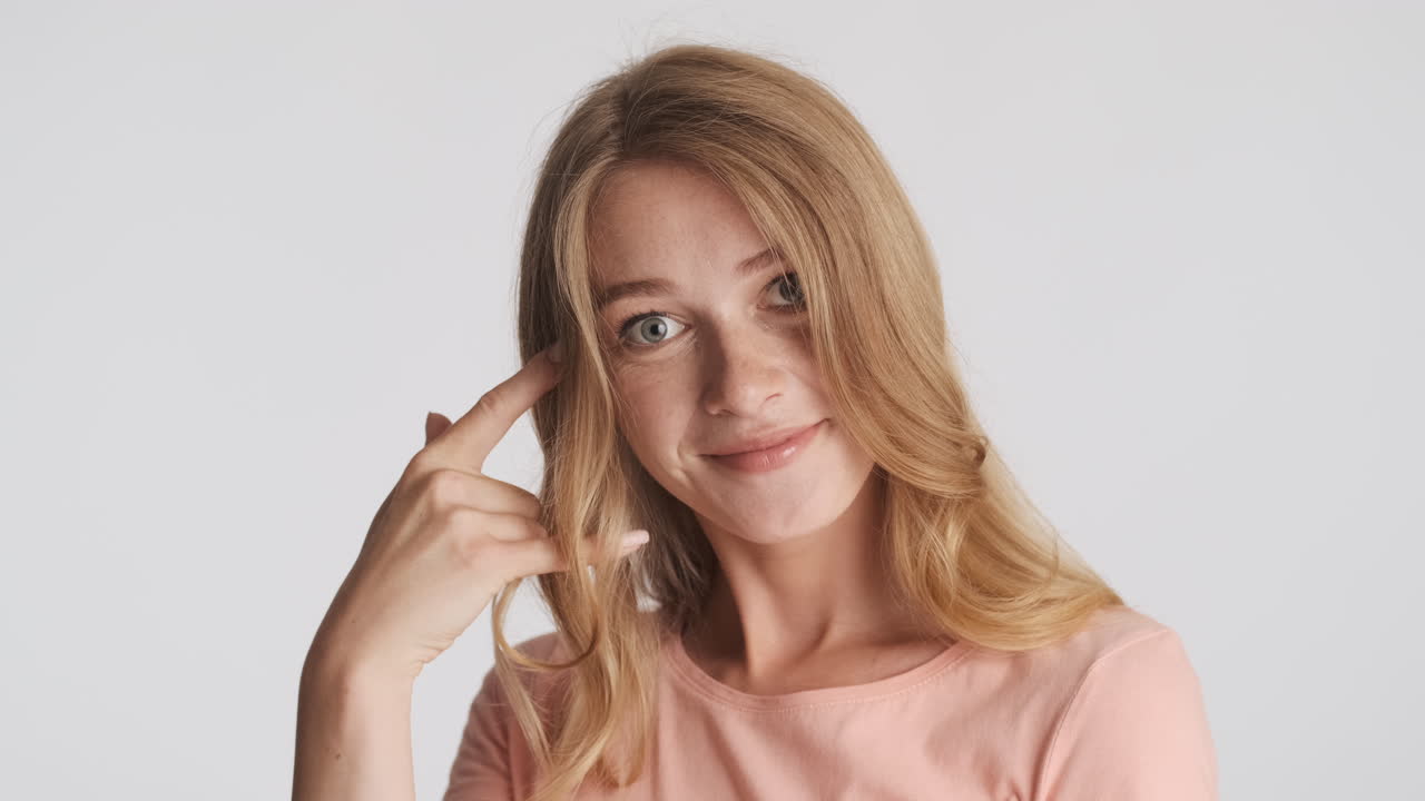 백인 여성이 카메라에 제스처를 보여줍니다.