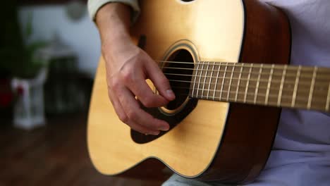 Close-up-of-man's-hands-playing-acoustic-guitar.-Musical-instrument-for-recreation-or-hobby-passion-concept.-Outdoors