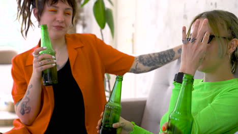 Friends-Having-A-Good-Time-While-Holding-Beer-Bottles-On-A-Home-Party